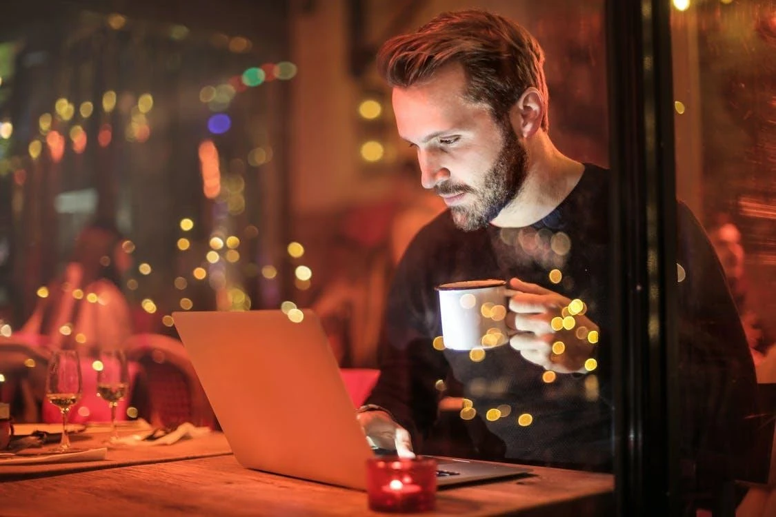 How to Find Items to Sell on Amazon - Man Looking for Items on His Laptop